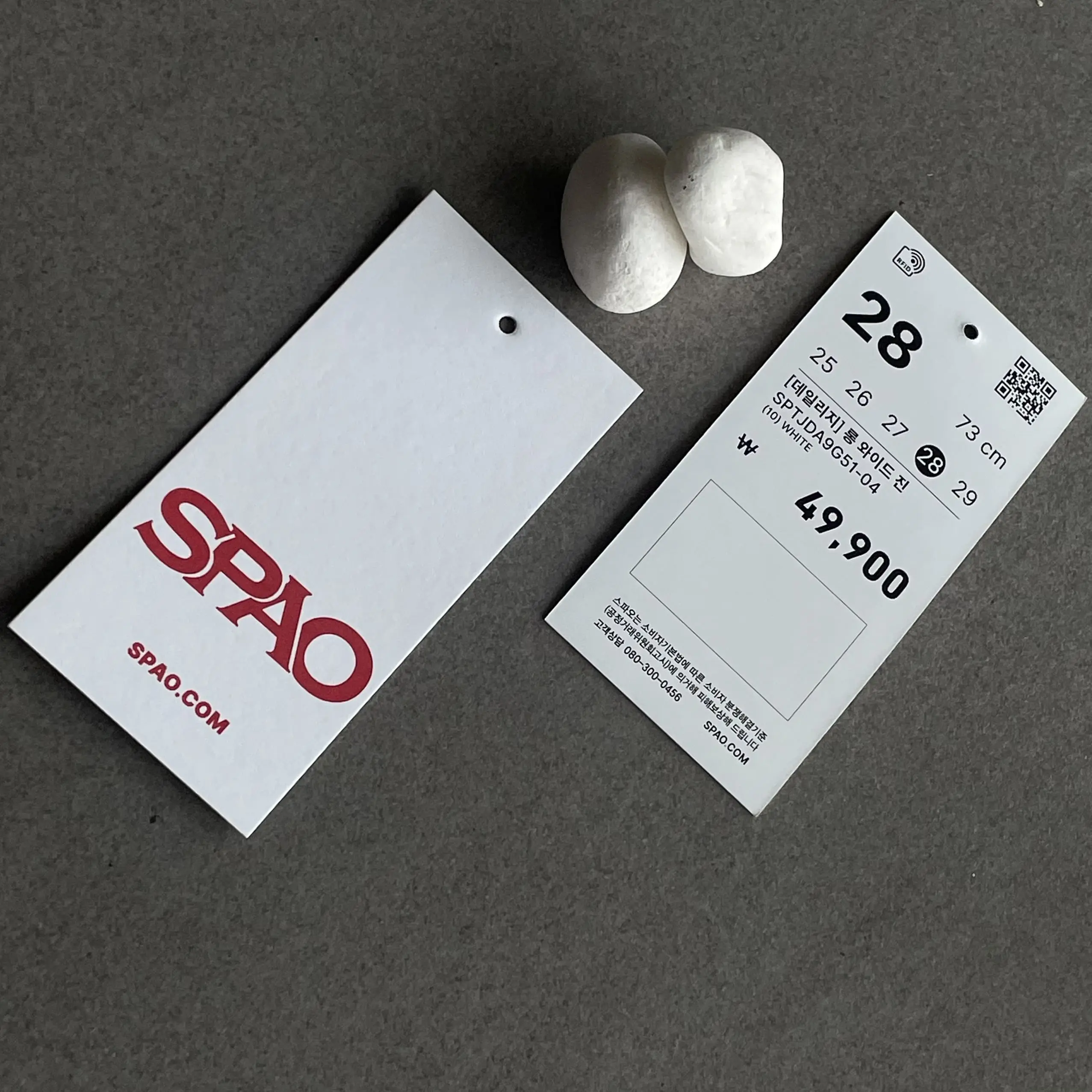 SPAO clothing price tag featuring a minimalist design, red logo on a white background, and clear product details.